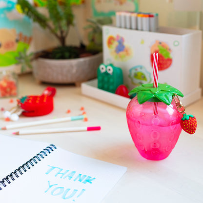 Strawberry cup shown with kawaii desk setup