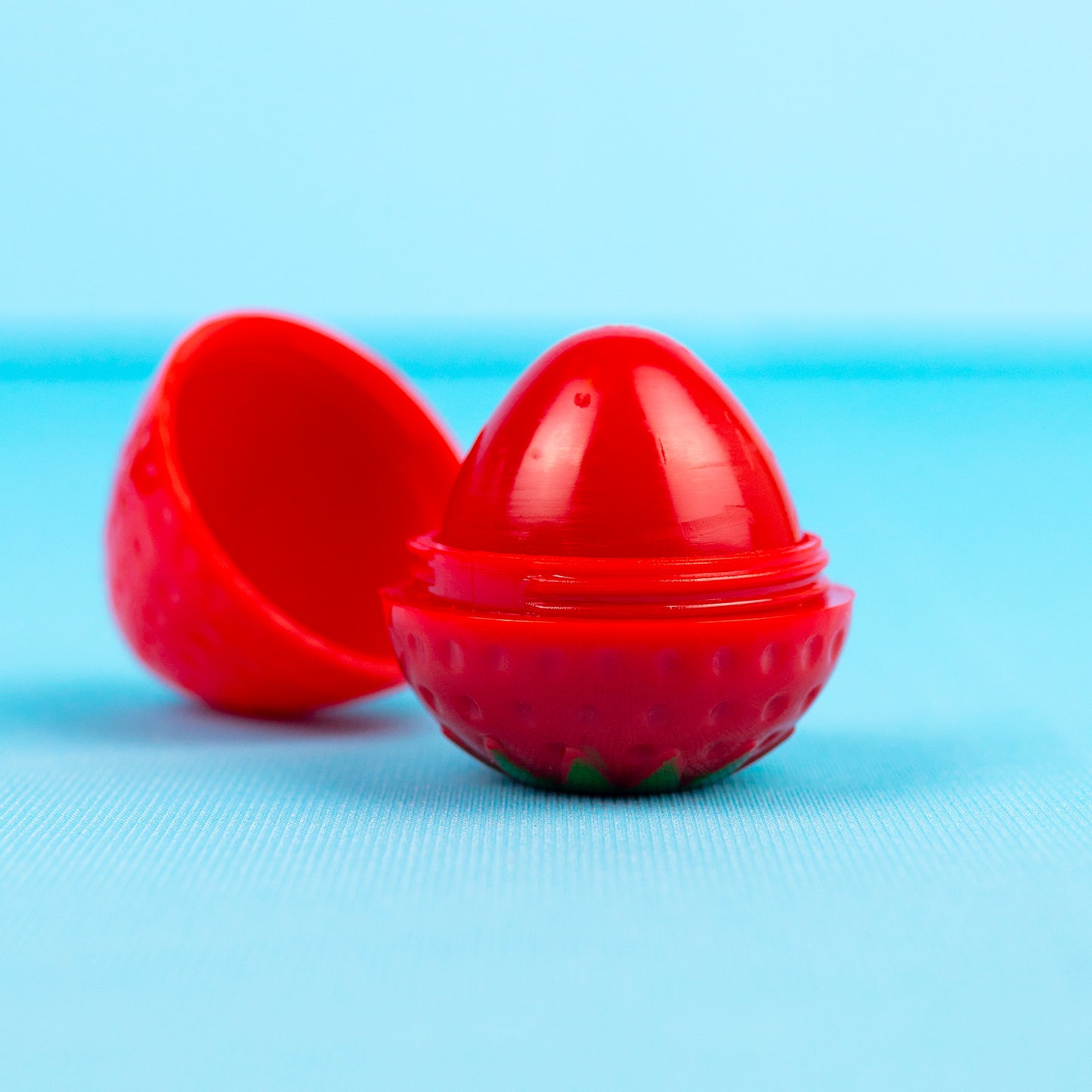 Strawberry lip balm with cap taken off