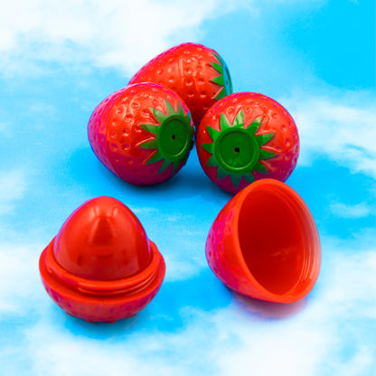 Four strawberry lip balms and one has the cap taken off