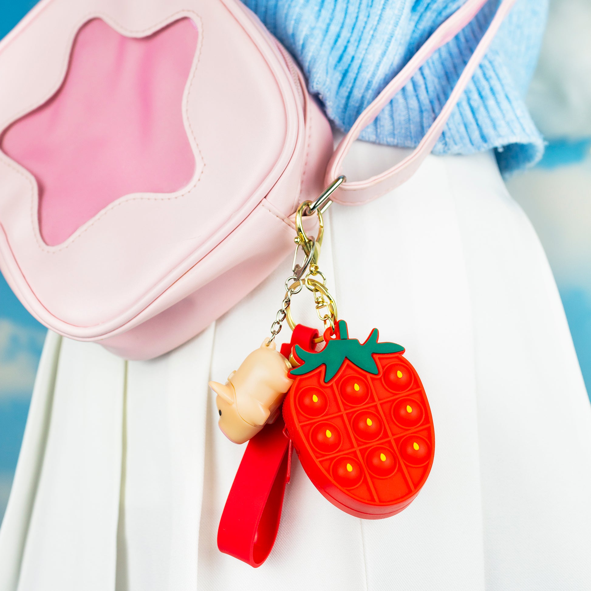 Strawberry fidget toy clipped to bag